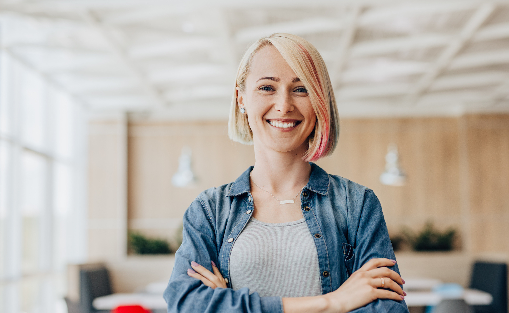 A smiling blonde woman in an office